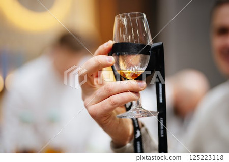 Celebrating fine spirits at a distillery tour in an elegant tasting room Celebrating fine spirits at a distillery tour in an elegant tasting room 125223118
