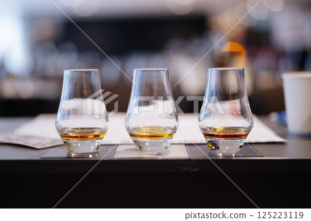 Crafting flavors with whiskey tasting at a modern bar venue Crafting flavors with whiskey tasting at a modern bar venue 125223119