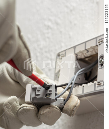 Electrician at work on a residential electrical system. Electricity. Electrician at work on a residential electrical system. Electricity. 125223165