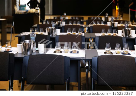 Tables arranged for an elegant whiskey tasting event in a modern venue 125223387