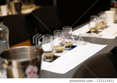 Experience of whiskey tasting at a sophisticated event in the evening Experience of whiskey tasting at a sophisticated event in the evening 125223412