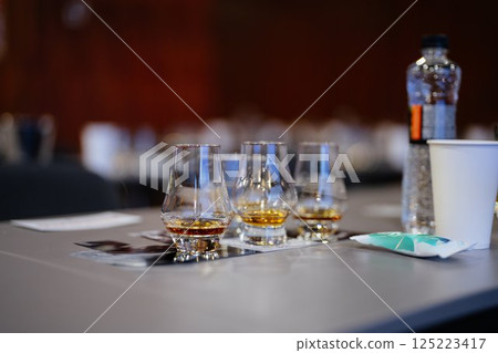 Enjoying fine whiskey samples at a tasting event in an elegant setting Enjoying fine whiskey samples at a tasting event in an elegant setting 125223417