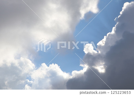 Stunning Clouds with Beautiful Rays of Sunlight Majestically Breaking Through the Sky Stunning Clouds with Beautiful Rays of Sunlight Majestically Breaking Through the Sky 125223653