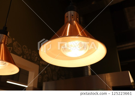 A Stylish Copper Pendant Light Fixture Perfectly Accentuates the Modern Kitchen Aesthetic 125223661