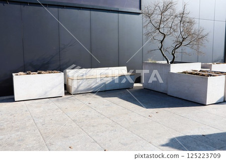 A Modern Minimalist Outdoor Bench and Planters Designed for a Serene and Chic Aesthetic 125223709
