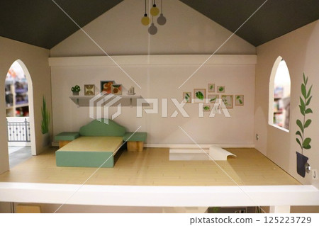 Contemporary Dollhouse Interior Featuring a Minimalist Design Alongside Charming Green Accents 125223729