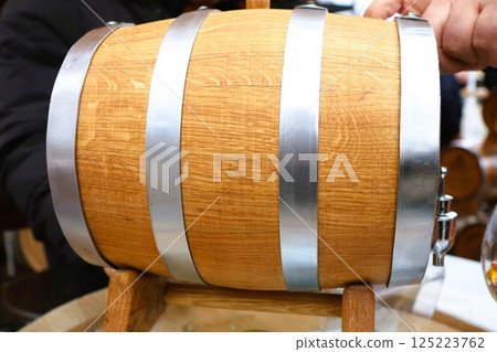 A beautifully handcrafted wooden barrel featuring durable metal bands for added strength 125223762