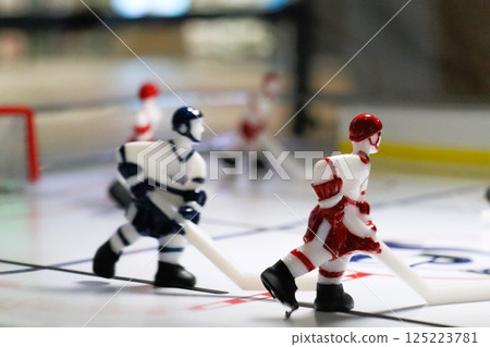 Enjoy the thrilling excitement of a Tabletop Hockey Game with Miniature Players on an arena 125223781