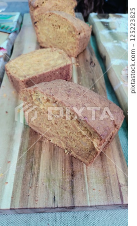 A Selection of Freshly Baked Artisan Bread Displayed Beautifully on a Wooden Plank A Selection of Freshly Baked Artisan Bread Displayed Beautifully on a Wooden Plank 125223825