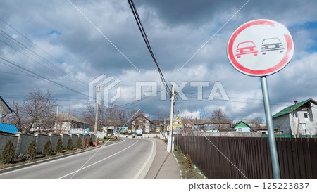 A Quiet Road with a No Parking Sign in a Peaceful Residential Area Surrounded by Nature 125223837