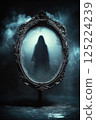 Eerie silhouette in glowing antique mirror with foggy ambiance 125224239