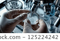 Scientist Examines Sample Under Microscope in Laboratory Environment 125224242