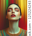 Vivid close-up portrait with bold makeup on colorful abstract background 125224243
