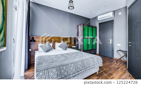 Modern Minimalist Bedroom Design Featuring Stylish Elements, Neutral Tones, and Unique Furnishings for Comfort and Aesthetic Appeal in a Cozy Space 125224726