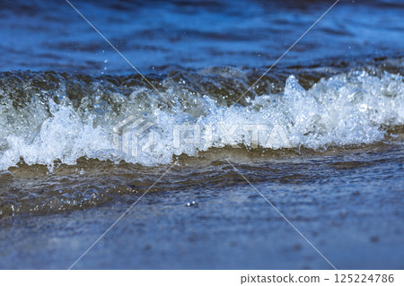 Captivating Ocean Wave Cresting on a Serene Beach, Displaying the Beauty of Nature's Power and Tranquility, Evoking a Sense of Peace and Connection to the Great Outdoors Captivating Ocean Wave Cresting on a Serene Beach, Displaying the Beauty of Nature's Power and Tranquility, Evoking a Sense of Peace and Connection to the Great Outdoors 125224786