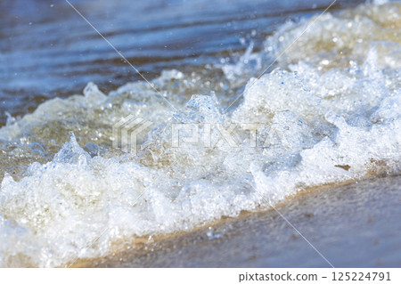 Capturing the Essence of Waves: A Beautiful Close-Up of Ocean Water Crashing Against the Shore, Highlighting the Power and Beauty of Nature in a Stunning Display Capturing the Essence of Waves: A Beautiful Close-Up of Ocean Water Crashing Against the Shore, Highlighting the Power and Beauty of Nature in a Stunning Display 125224791