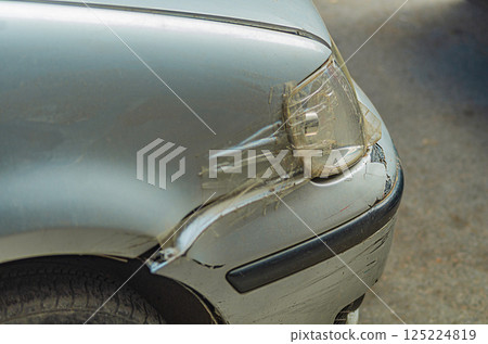 Damaged front right fender and bumper of a silver car with scratches and chips. Insured event, compensation for damage Damaged front right fender and bumper of a silver car with scratches and chips. Insured event, compensation for damage 125224819