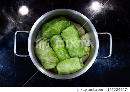 Delicious Cabbage Rolls Cooking in a Modern Stainless Steel Pot on a Dark Kitchen Surface Ready for a Flavorful Meal Experience from Scratch 125224837