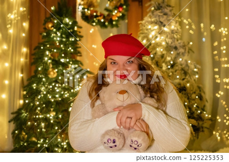 Woman Christmas Teddy Bear Festive Decorated Room Smiling Holding Plush Toy Winter Holiday Season Cheerful Cozy Atmosphere Celebration Warm Lights Festive Season 125225353