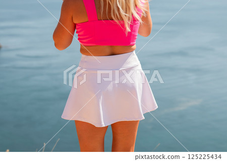 A woman wearing a pink top A woman wearing a pink top 125225434