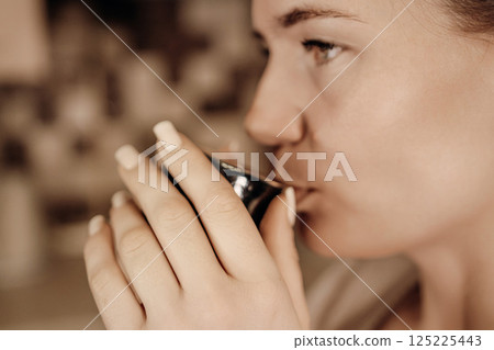 Woman Tea Ceremony Cup Japan: Traditional tea drinking ritual, close-up, serene moment. 125225443