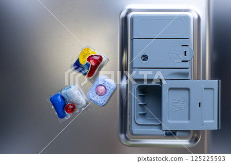 High-Quality Image of Colorful Dishwasher Pods and a Dishwasher Detergent Compartment, Captured in a Modern Kitchen Setting with Stainless Steel Finish High-Quality Image of Colorful Dishwasher Pods and a Dishwasher Detergent Compartment, Captured in a Modern Kitchen Setting with Stainless Steel Finish 125225593