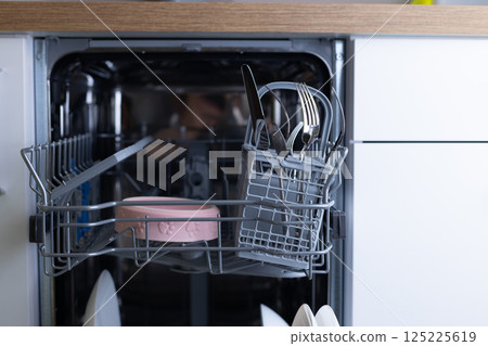 Close-up View of a Modern Dishwasher Interior Showcasing Clean Plates, Cutlery, and a Unique Pink Pet Bowl in a Sleek Kitchen Environment with Modern Design Touches Close-up View of a Modern Dishwasher Interior Showcasing Clean Plates, Cutlery, and a Unique Pink Pet Bowl in a Sleek Kitchen Environment with Modern Design Touches 125225619