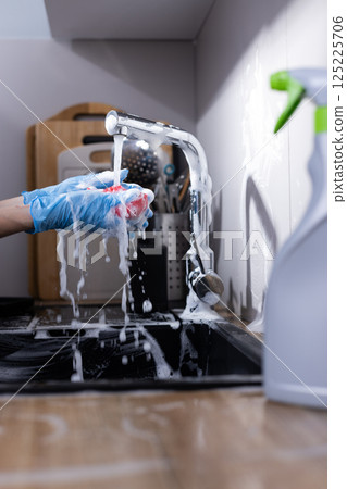Cleaning the Kitchen Sink: A Foamy Experience with Soap and Water in a Modern Kitchen Environment Focused on Hygiene and Domestic Chores 125225706