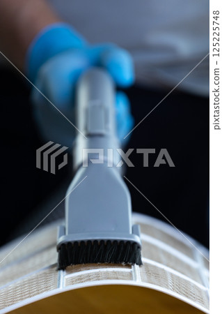 Close-Up Shot of a Cleaning Tool Designed for Surface Care, Featuring a Brush Attachment on a Light-Colored Surface, Captured in a Well-Lit Environment for Maximum Clarity 125225748