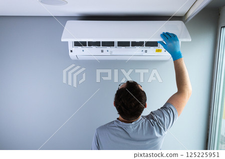 Professional Maintenance of Air Conditioning Unit: Expert Checking Filters and Functionality for Efficient Cooling and Air Quality Improvement Professional Maintenance of Air Conditioning Unit: Expert Checking Filters and Functionality for Efficient Cooling and Air Quality Improvement 125225951
