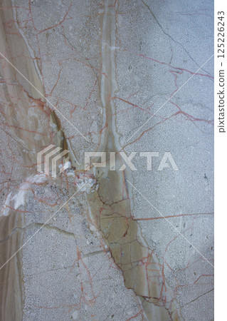 Close-up of light marble slab with red mineral veins 125226243