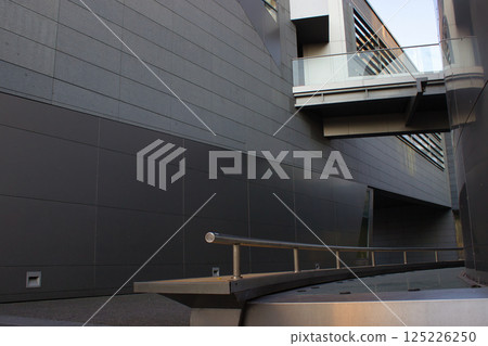 Modern urban architecture with curved walkway and bridge Modern urban architecture with curved walkway and bridge 125226250