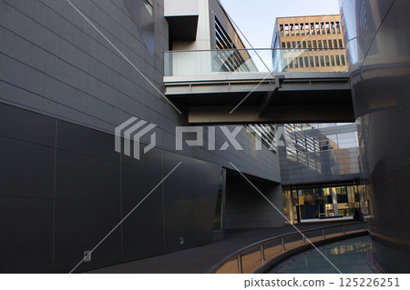 Contemporary alley between steel and glass office buildings Contemporary alley between steel and glass office buildings 125226251