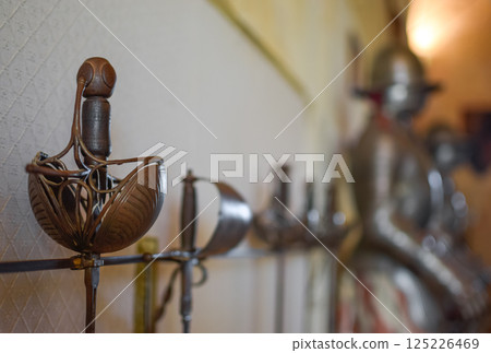 Close view Medieval Sword Exposed with White Background of Castle and Armor Close view Medieval Sword Exposed with White Background of Castle and Armor 125226469