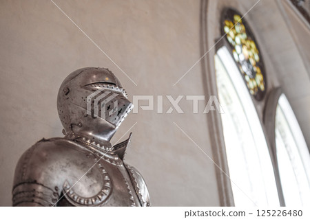 Close view of Medieval shiny armor and gothic pointed arches in white background Close view of Medieval shiny armor and gothic pointed arches in white background 125226480