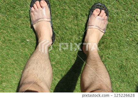 Leg hair of a man wearing sandals 125226628