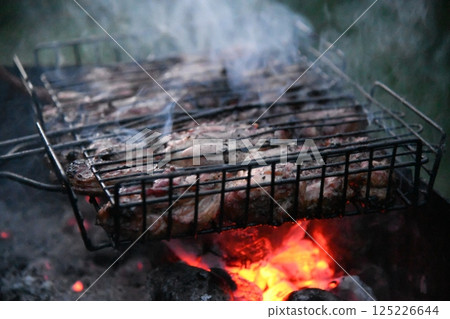 Beef steak on the grill with smoke and Beef steak on the grill with smoke and 125226644