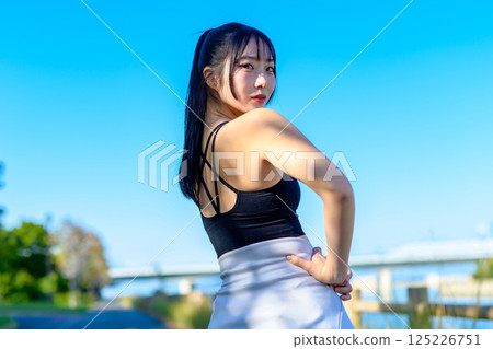 藍天下運動的酷女人的背影,回頭看,節食,運動,鍛煉,修剪 藍天下運動的酷女人的背影,回頭看,節食,運動,鍛煉,修剪 125226751