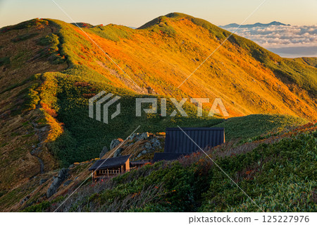 Mount Tainai and the Asahi mountain range at sunrise as seen from Mount Monnai in the Iide mountain range 125227976