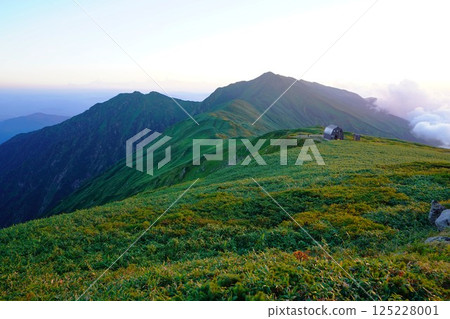 Gonishi hut in the Iide mountain range and Mount Dainichi bathed in the setting sun 125228001