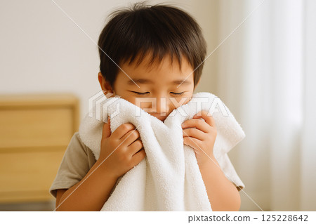 Boy wiping his face with a towel Image of face washing 125228642