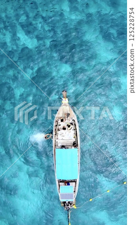 Boat floating on clear water Boat floating on clear water 125228754