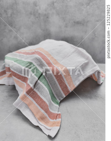 Dough rising under striped cloth on kitchen counter Dough rising under striped cloth on kitchen counter 125229825