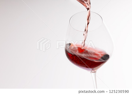 Red wine poured into a glass Red wine poured into a glass 125230590