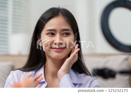Beauty broker demonstrating skincare routine during a live broadcast session Beauty broker demonstrating skincare routine during a live broadcast session 125232173