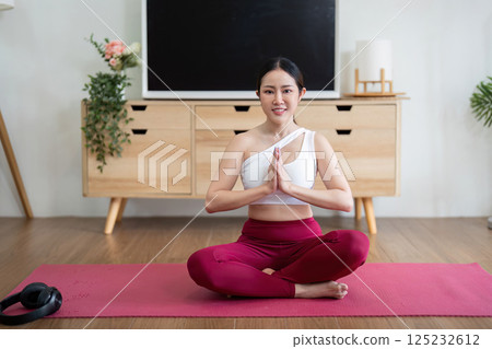 Yoga and Serenity. A woman practicing yoga in a seated position, embodying peace and mindfulness. 125232612