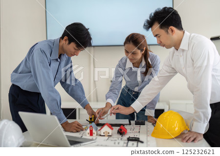 Collective Teamwork in Home Design. Professionals collaborating on architectural concepts and hands-on application. 125232621