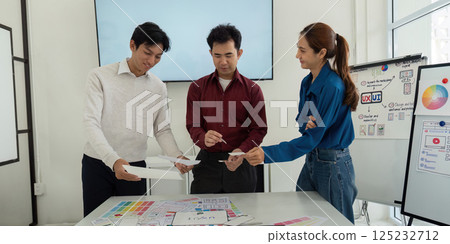 Design Workshop and Interactive Learning. Team members exchanging wireframe ideas in a productive environment. Design Workshop and Interactive Learning. Team members exchanging wireframe ideas in a productive environment. 125232712