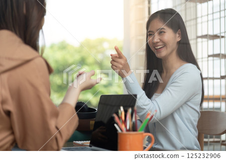 Joyful Learning and Connection. A student enthusiastically explaining a concept to her friend during their study time. Joyful Learning and Connection. A student enthusiastically explaining a concept to her friend during their study time. 125232906