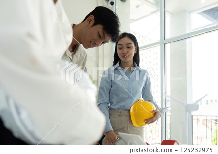 Teamwork and Innovation. A group of professionals assessing the impact of renewable energy in engineering design. Teamwork and Innovation. A group of professionals assessing the impact of renewable energy in engineering design. 125232975